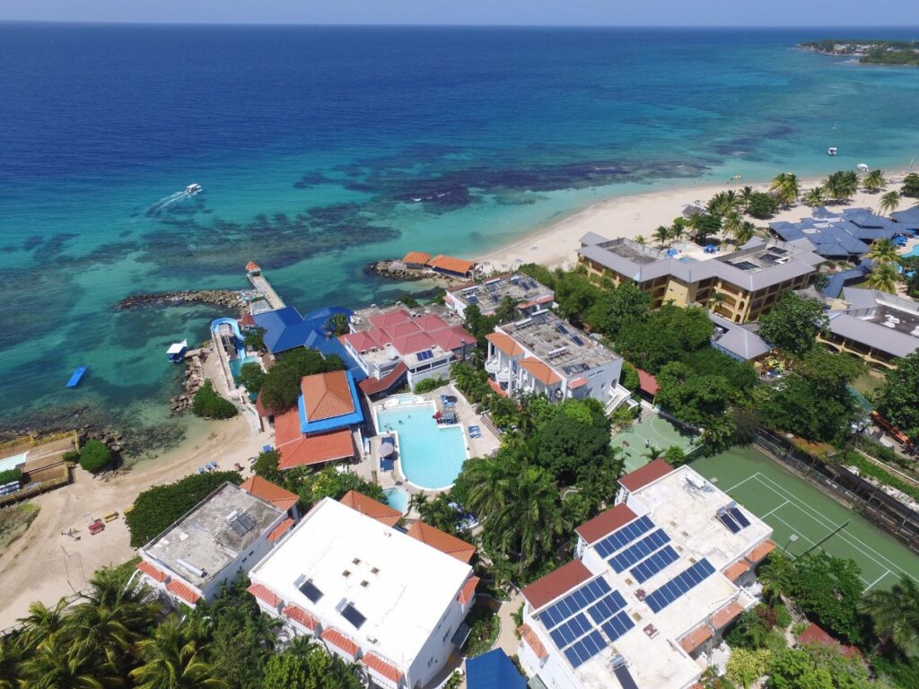 Aerial view of Franklyn D Resort & Spa’s beachfront suites beside crystalline waters
