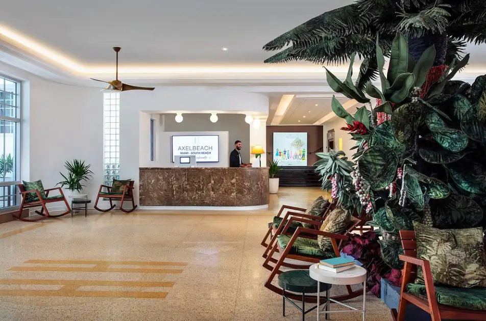 AxelBeach Miami South Beach’s lobby framed by tropical palms and terrazzo floors