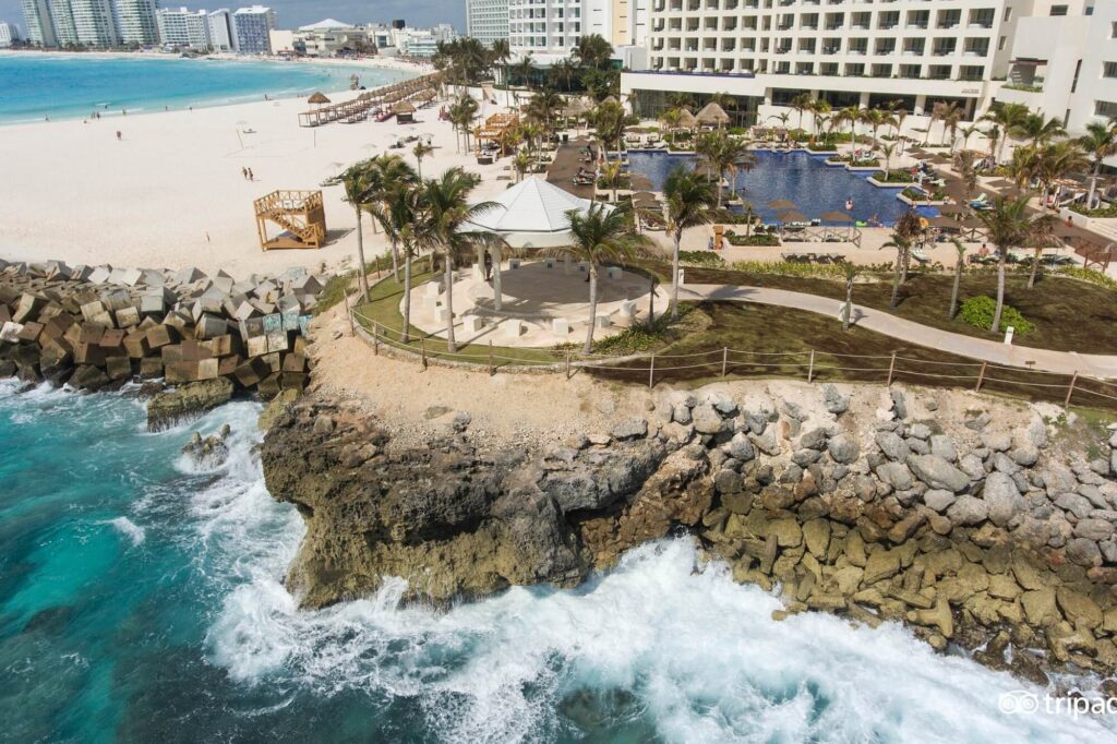 Balconies of Hyatt Ziva Cancun overlook endless turquoise ocean and white sands