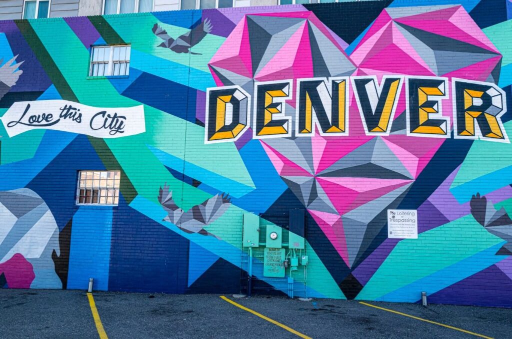 Bold geometric heart mural spelling out Denver on a RiNo warehouse wall