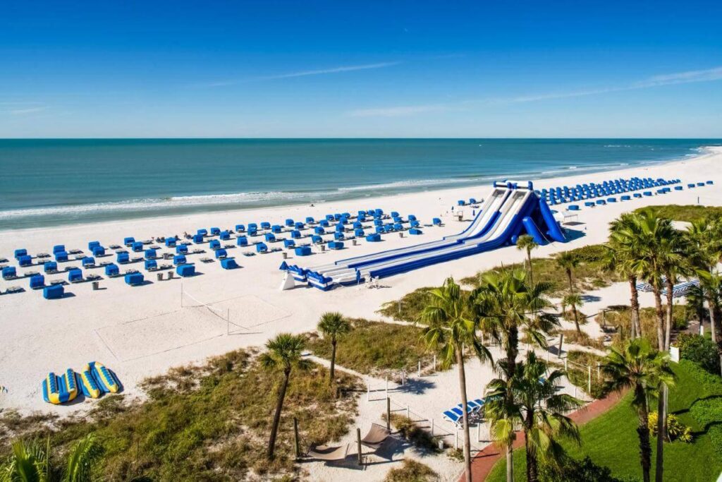 Cabanas and slides arrayed on white sands at Tradewinds Island Grand Beach Resort