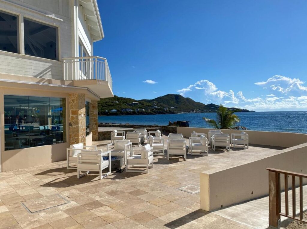 Carina Bay Boutique’s waterfront villas stretching along golden sands beside emerald bay