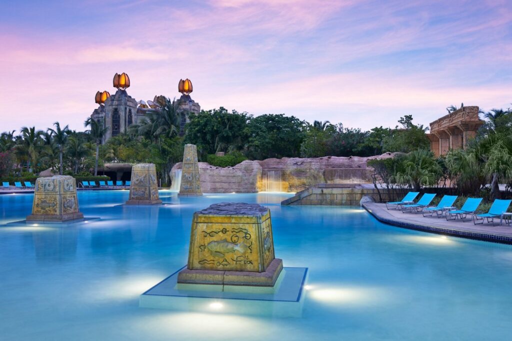 Carved pillars rise from the tranquil lagoon at Atlantis Paradise Island, Bahamas
