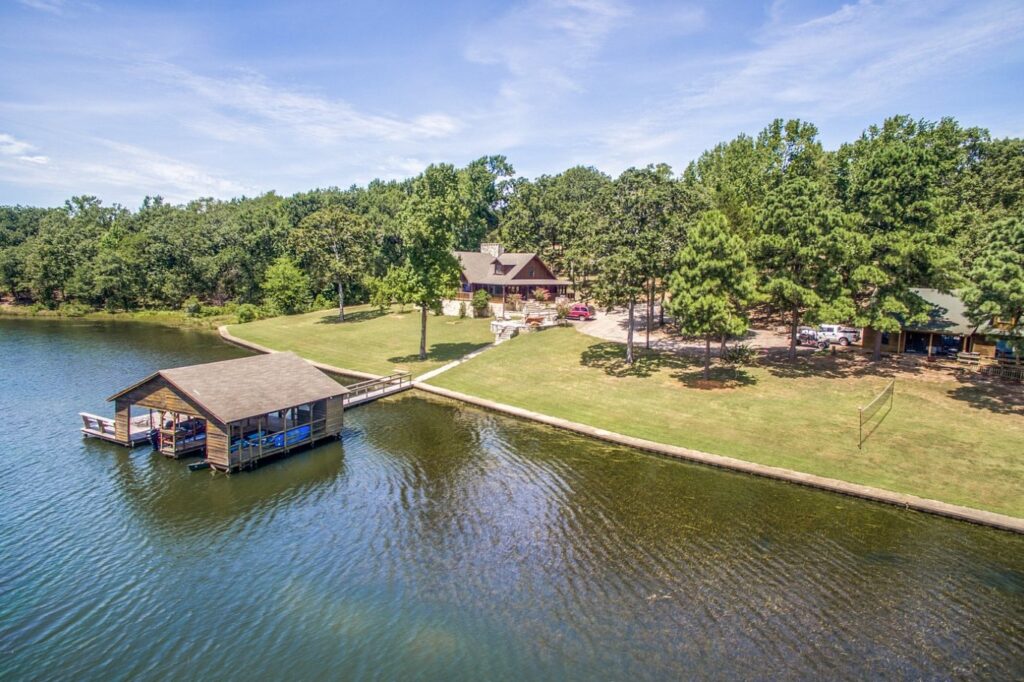 Cedar Cove Ranch’s lakeside cabins framed by pine-shaded lawns and a floating boathouse