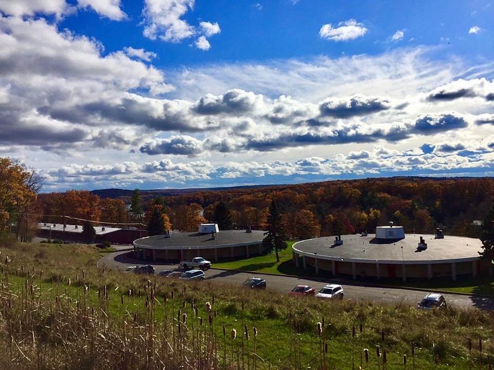 Cove Haven Resort’s round lakeside cabins nestled among autumn-tinted hills under a bright sky