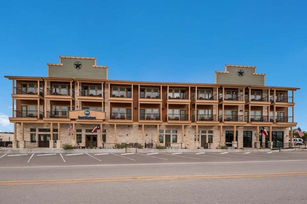 Covered balconies and star emblem at Best Western Bandera Suites & Saloon in Bandera, Texas