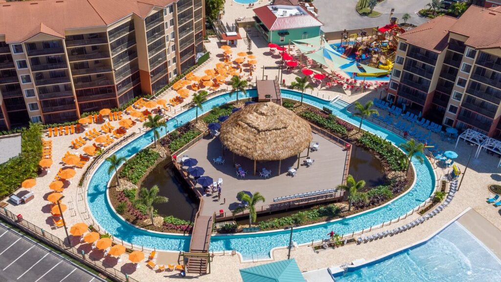 Lazy river looping around a tropical tiki hut at Westgate Lakes Resort & Spa