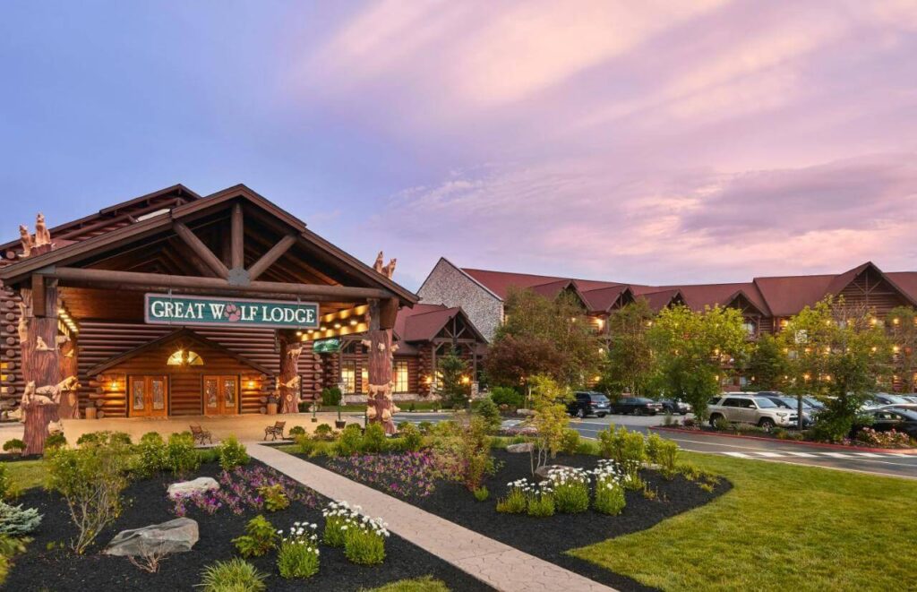 Log-cabin entrance beckons families to Great Wolf Lodge Poconos under pastel skies
