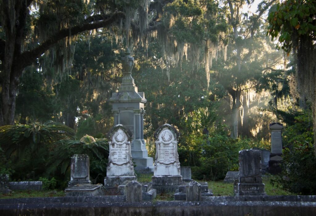 Moss-shrouded tombstones casting long shadows in Savannah’s storied cemetery