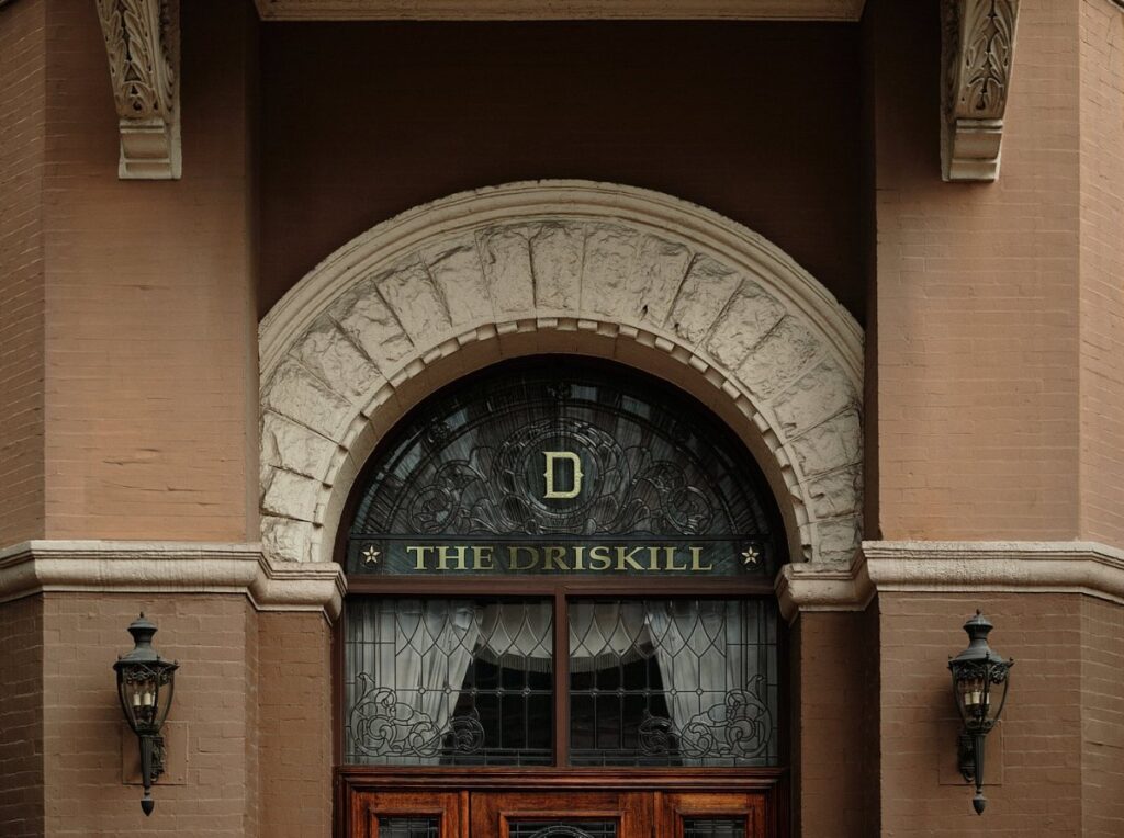 Ornate arched doorway bearing The Driskill name in historic downtown Austin