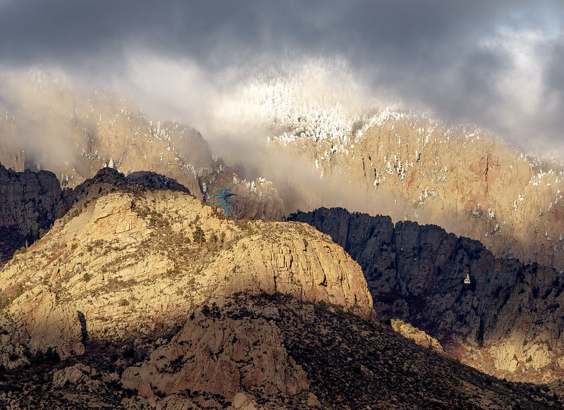 Sandia Peak Tramway floats into snowy granite and swirling clouds