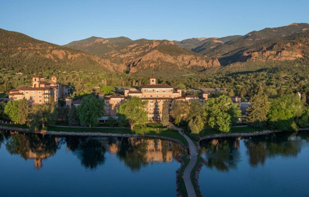 The Broadmoor’s grand façade reflects in its tranquil Colorado Springs lake