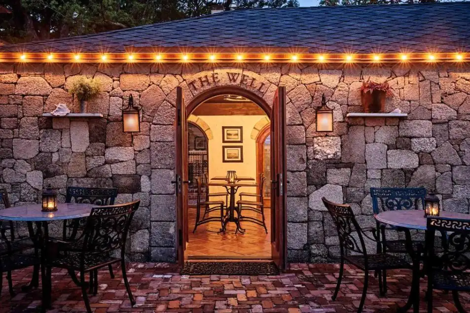 The Collector Inn’s stone courtyard aglow with evening lanterns