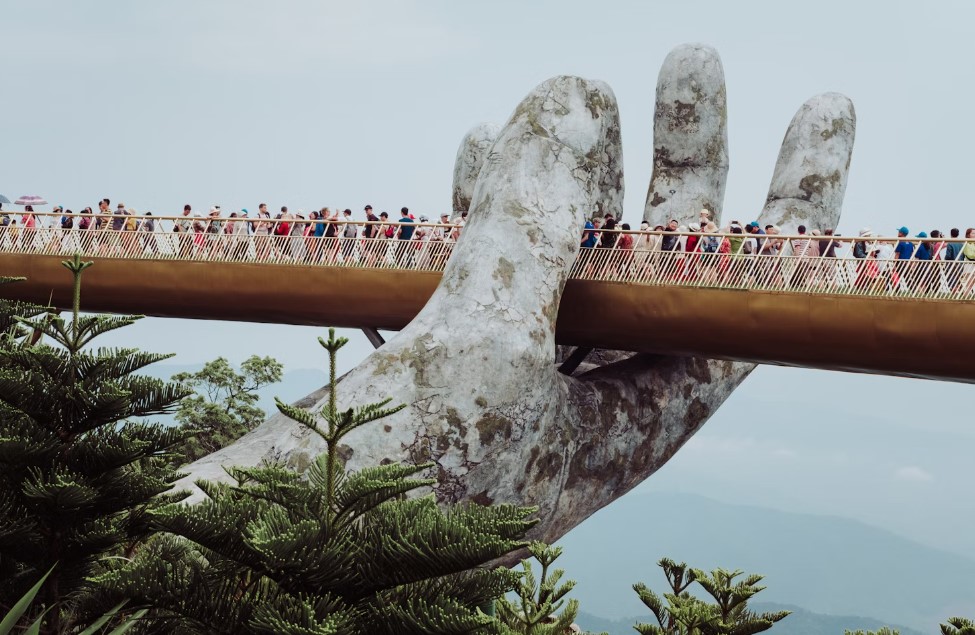 The Golden Bridge in Ba Na Hills, Vietnam, held aloft by giant stone hands.