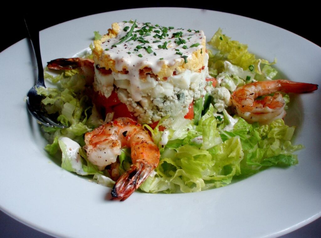Towering shrimp Cobb stack with blue cheese and creamy dressing at The Olde Pink House