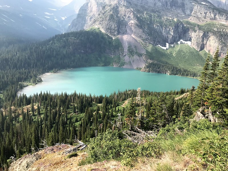 Emerald waters glow beneath towering cliffs at Grinnell Lake, Many Glacier