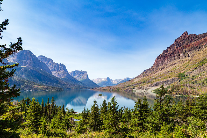Jagged peaks reflect in St. Mary Lake as Wild Goose Island floats at center in Glacier National Park