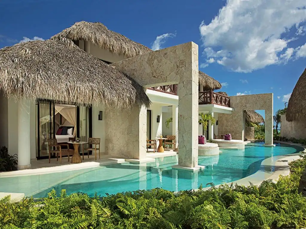 Thatched rooftops and swim-up suites bask in the sun at Secrets Cap Cana, Dominican Republic