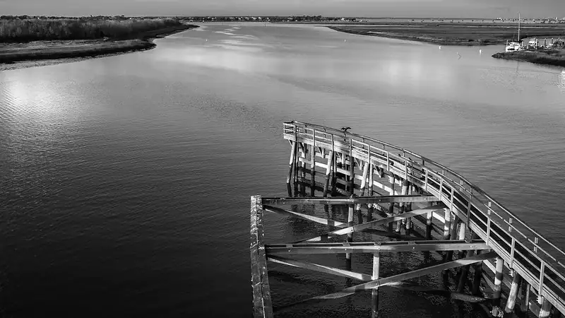 Tide flows beneath a winding boardwalk at Sullivan’s Island, South Carolina