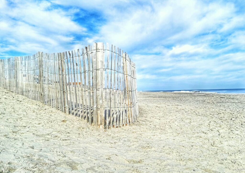 Weathered sand fence guarding the tranquil shores of Bethany Beach, Delaware