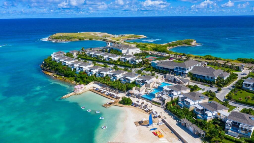 White villas curve around emerald coves at Hammock Cove, Antigua