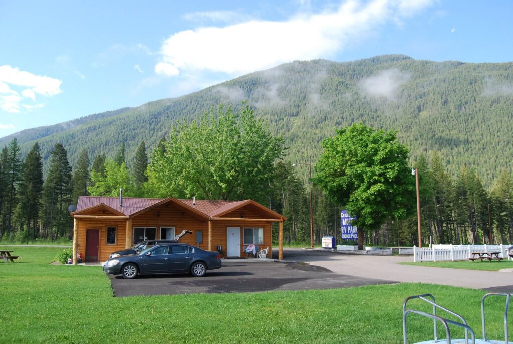 A cozy cabin nestled beneath forested slopes at Beargrass Lodging and RV Resort