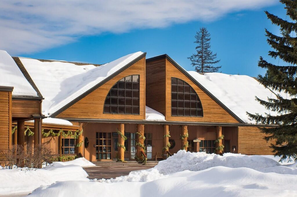 Snow-dusted timber façade of Grouse Mountain Lodge glowing under a clear winter sky at Grouse Mountain Lodge