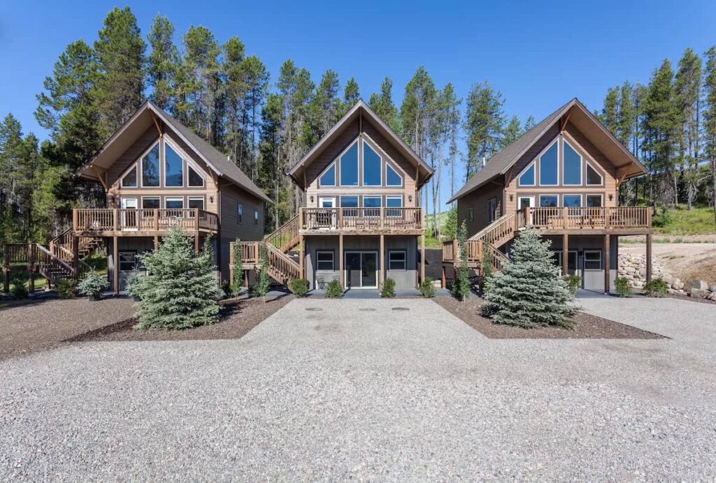 Three alpine chalets framed by pine forest one mile from Glacier National Park at Beautiful Chalet with Views One Mile from Glacier National Park